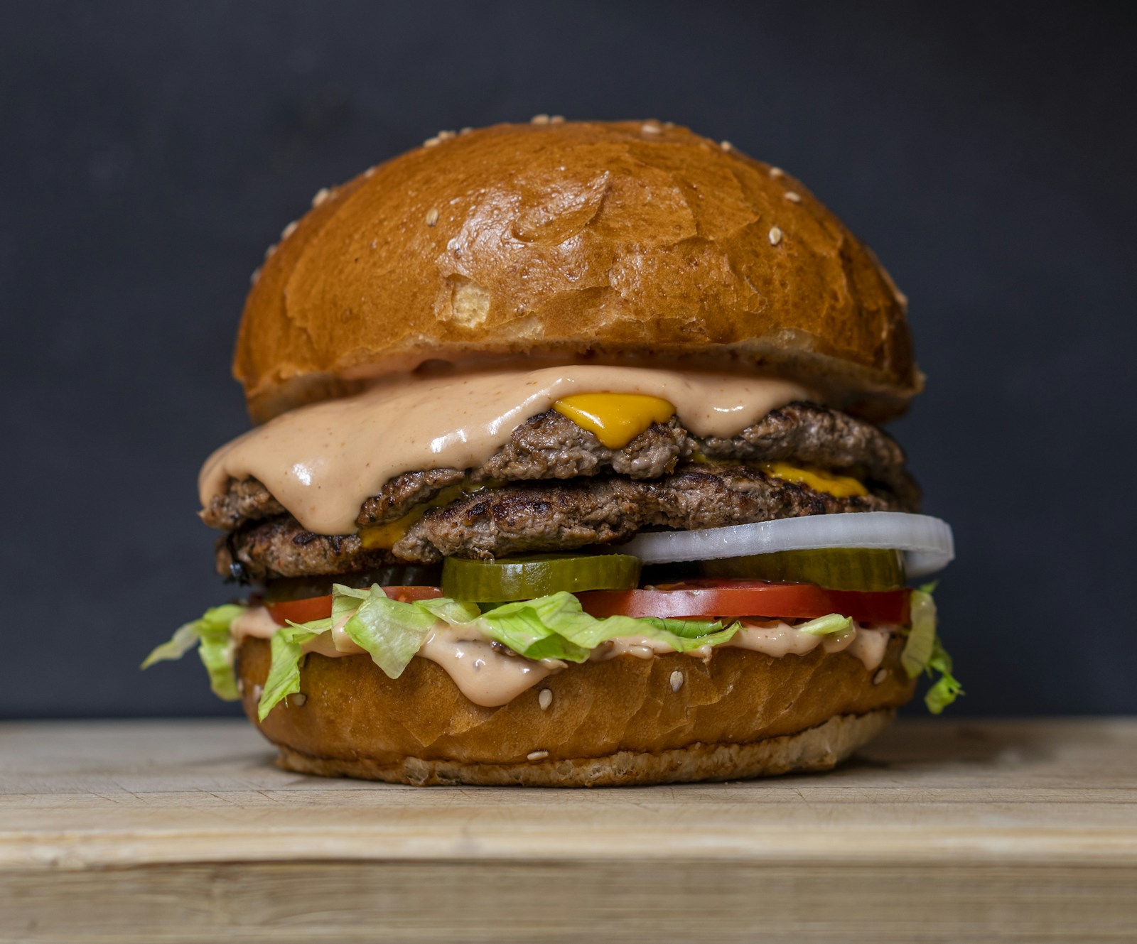 Illustrative stock photograph of a stacked cheeseburger; not a Yella Beak dish